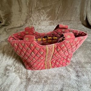 Quilted shoulder bag by MaggiB in soft red and gold.  Bag is 10 inches across